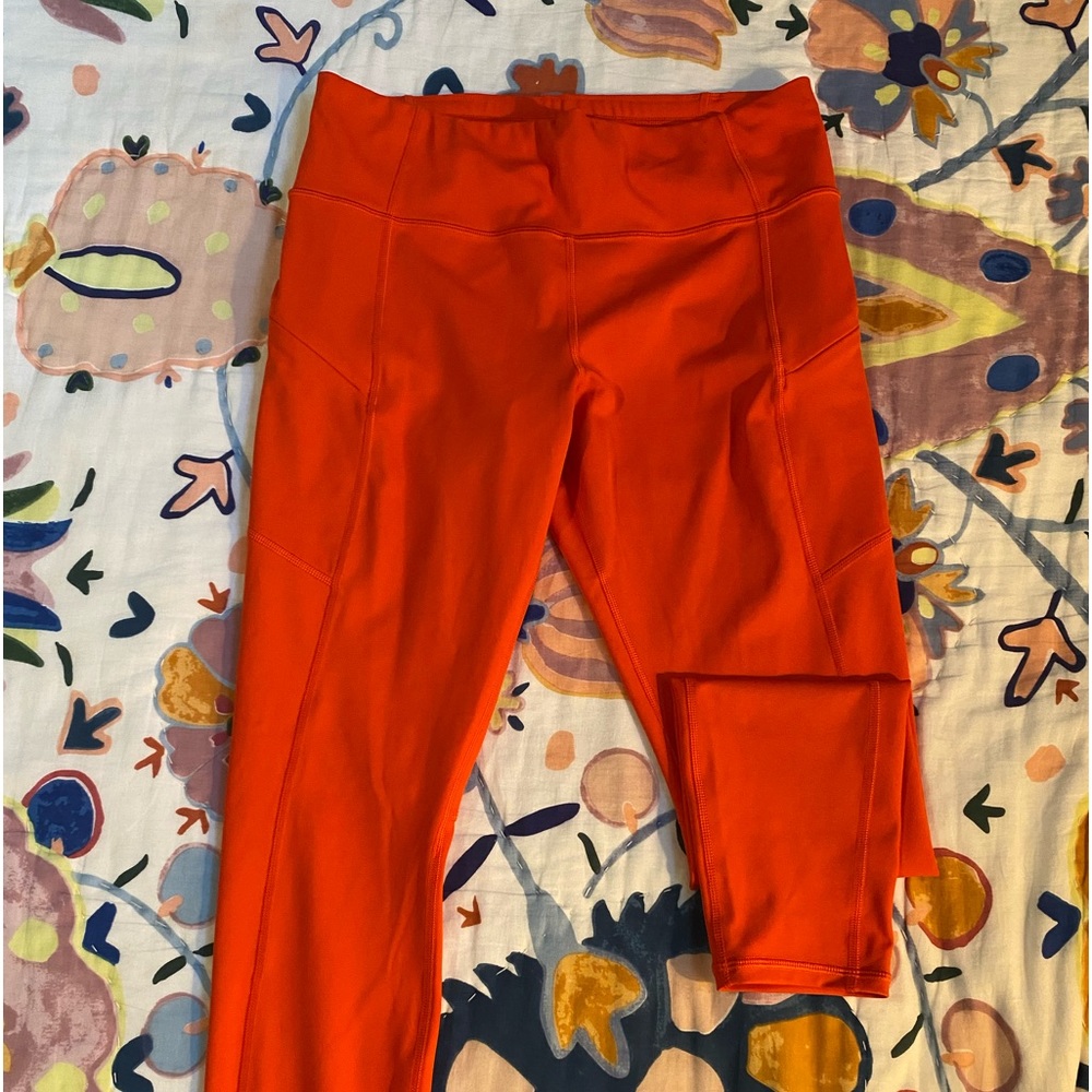 Athleta Orange leggings. Inside pocket for keys or money. Side zipper pockets.